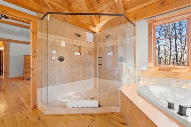 bathroom with hardwood / wood-style floors, independent shower and bath, wood ceiling, and vaulted ceiling with beams