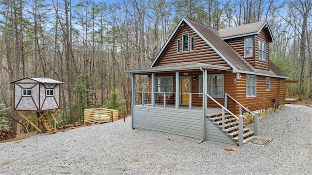 view of front of home featuring a porch and roof with shingles
