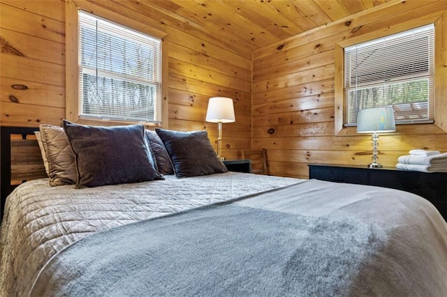 bedroom featuring multiple windows, wooden walls, and wood ceiling