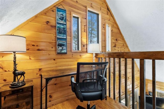 office space featuring wood walls and vaulted ceiling