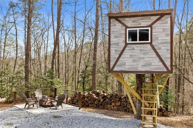 view of patio with an outdoor fire pit and stairway