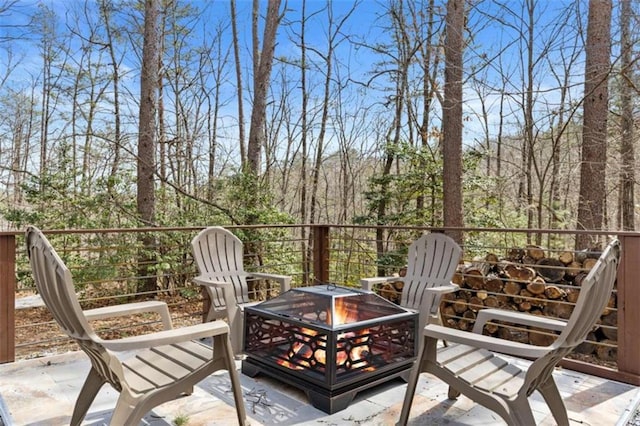 wooden terrace featuring a fire pit