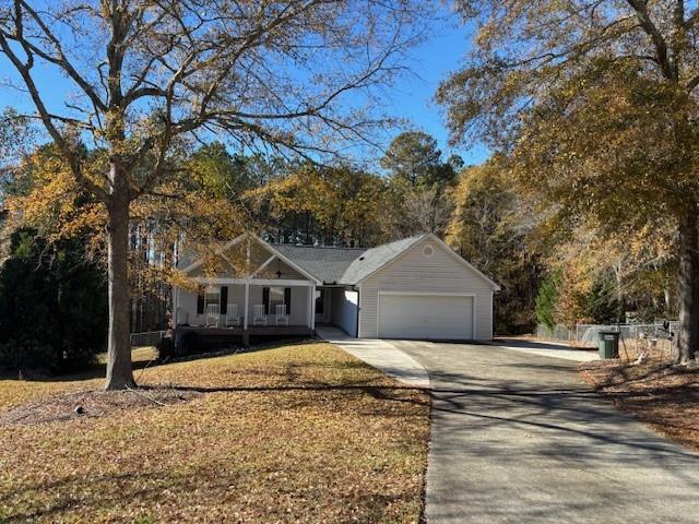 view of front of house featuring a porch and a garage