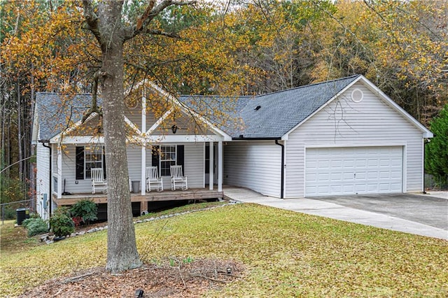 single story home with a porch, a garage, a front yard, and central AC