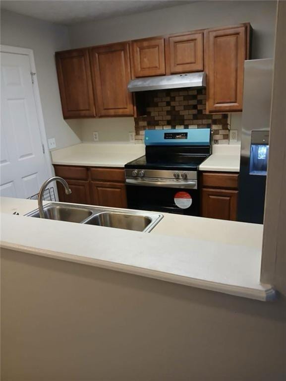 kitchen with appliances with stainless steel finishes, tasteful backsplash, and sink