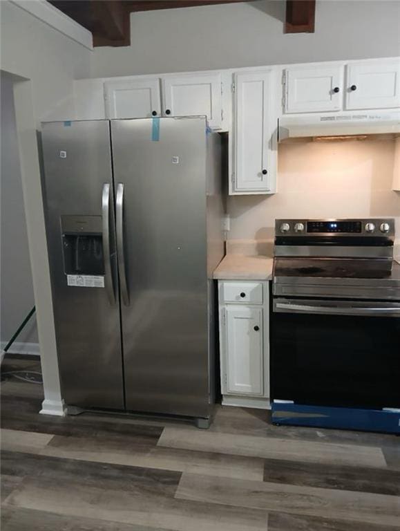 kitchen featuring dark hardwood / wood-style floors, appliances with stainless steel finishes, white cabinetry, and beamed ceiling