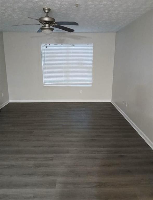 unfurnished room featuring dark hardwood / wood-style floors and a textured ceiling