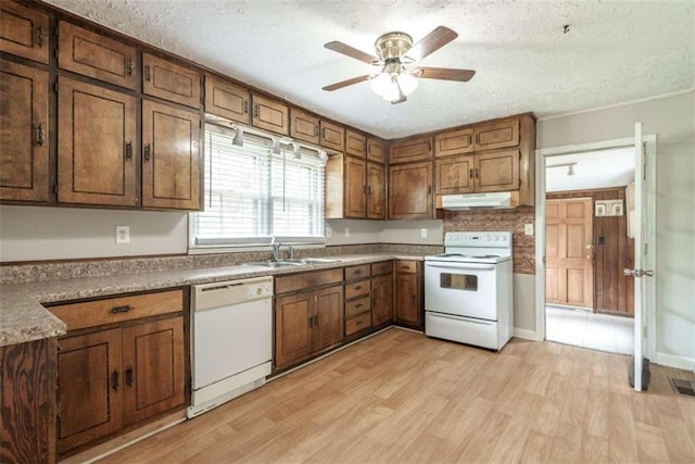 kitchen with a textured ceiling, ceiling fan, white appliances, and light hardwood / wood-style floors