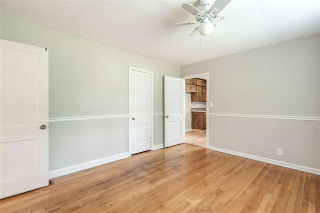 unfurnished bedroom featuring ceiling fan and hardwood / wood-style flooring