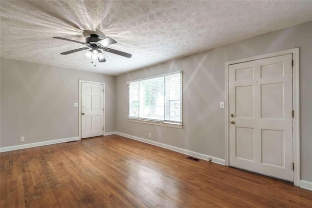 entrance foyer featuring a textured ceiling, hardwood / wood-style floors, and ceiling fan