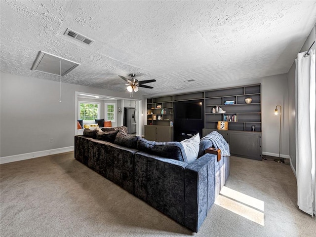 30 Court S, Ellenwood, GA 30294 - living area with attic access, carpet floors, a ceiling fan, a textured ceiling, and built in shelves