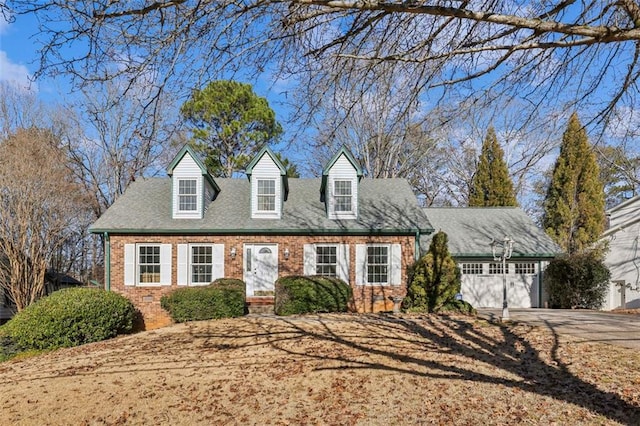 new england style home featuring a garage