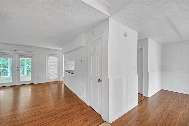 4440 Coventry Ct NE, Roswell, GA 30075 - entrance foyer with a textured ceiling, wood finished floors, and wainscoting