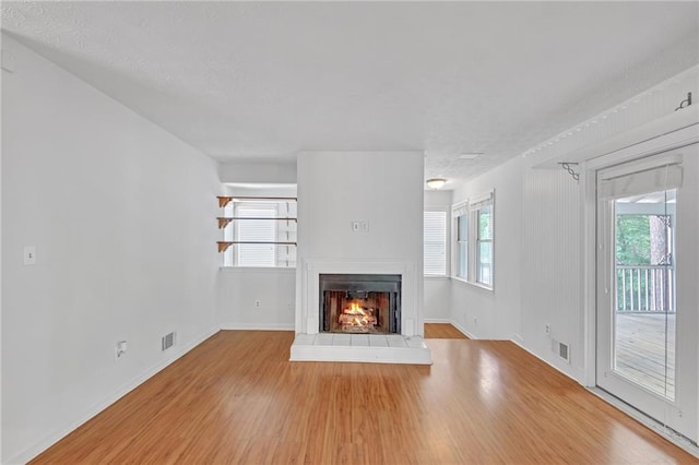 4440 Coventry Ct NE, Roswell, GA 30075 - unfurnished living room featuring wood finished floors, a lit fireplace, and baseboards