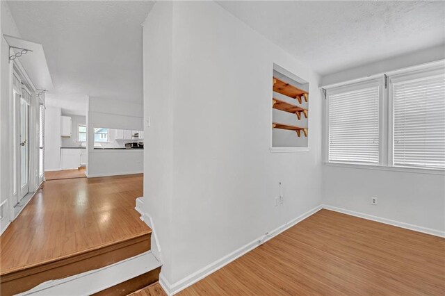 4440 Coventry Ct NE, Roswell, GA 30075 - hallway featuring wood finished floors and baseboards