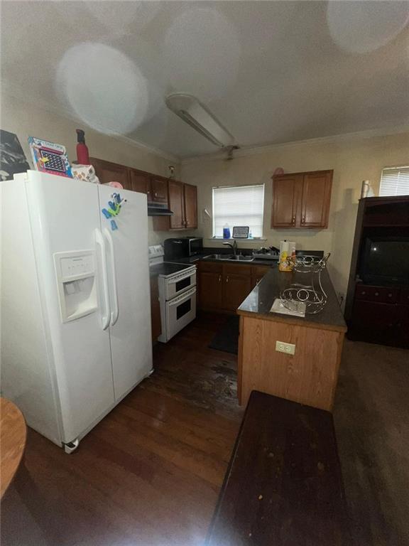 kitchen with dark wood-type flooring, sink, and white appliances