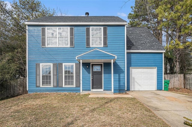 view of front of property featuring a garage and a front lawn