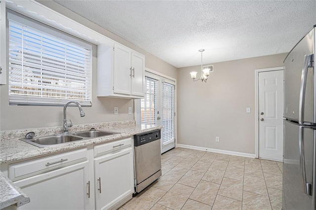 kitchen featuring sink, white cabinetry, a chandelier, pendant lighting, and appliances with stainless steel finishes