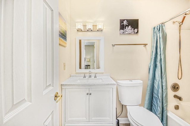 full bathroom with vanity, shower / bath combo, and toilet