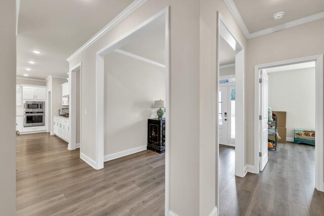 259 Dunagan Ct, Winder, GA 30680 - hallway with wood finished floors, crown molding, and recessed lighting