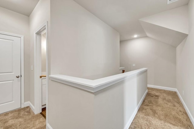 259 Dunagan Ct, Winder, GA 30680 - hall with light carpet, an upstairs landing, lofted ceiling, and recessed lighting