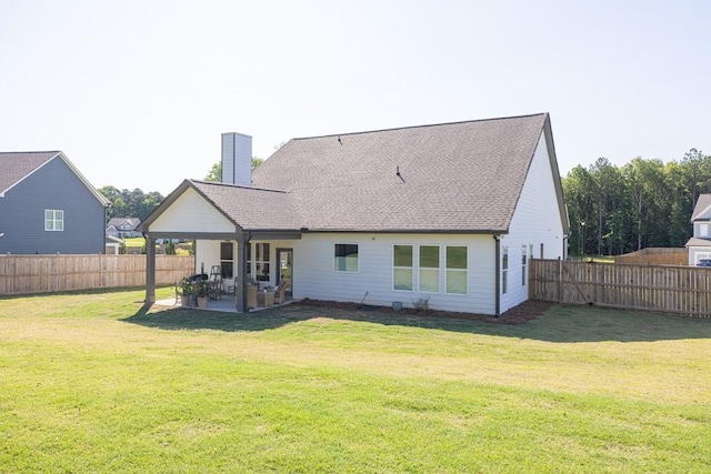 259 Dunagan Ct, Winder, GA 30680 - rear view of property with a chimney, a patio area, a fenced backyard, and a shingled roof