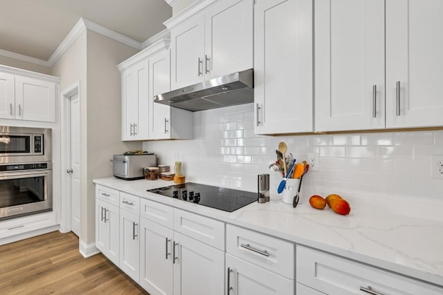 259 Dunagan Ct, Winder, GA 30680 - kitchen with stainless steel appliances, under cabinet range hood, crown molding, backsplash, and white cabinetry