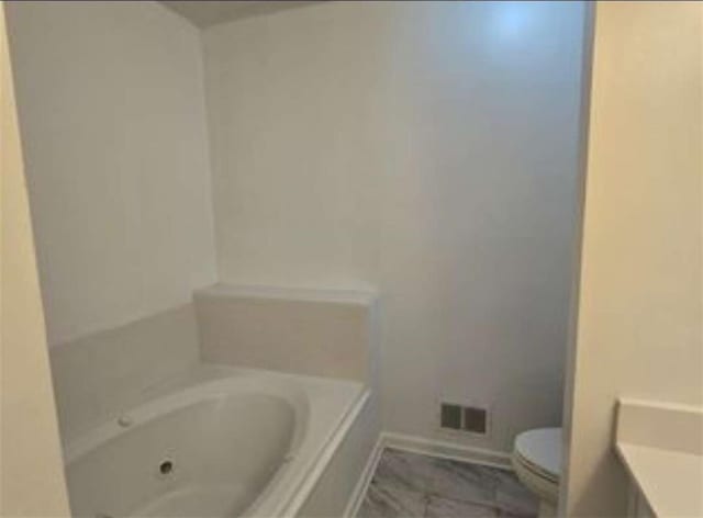 full bath with toilet, baseboards, and a bathing tub