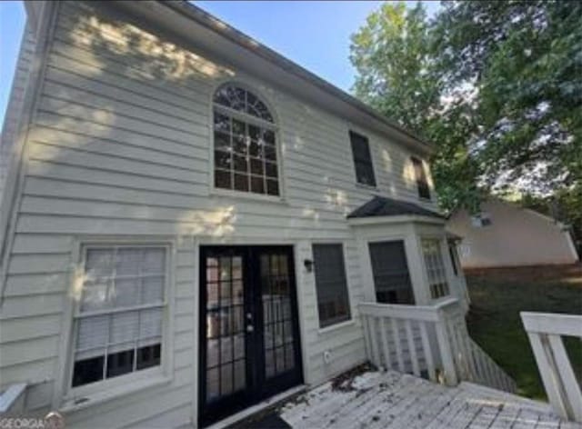 back of house with a wooden deck