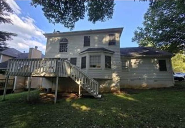 back of property featuring a lawn, stairs, and a deck