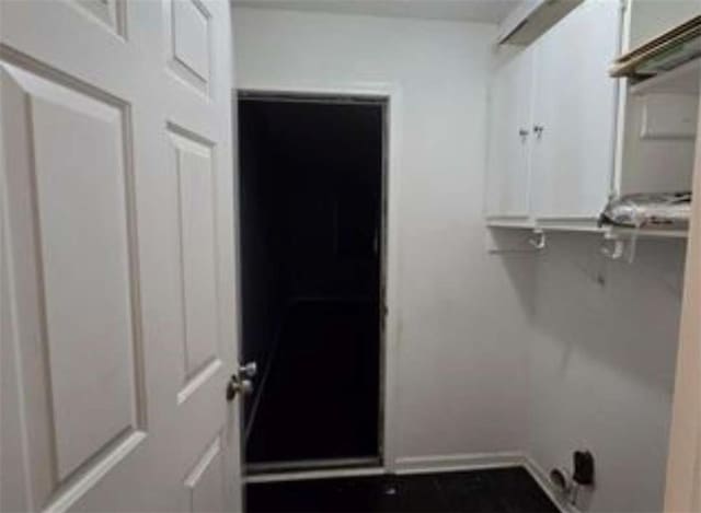 washroom with baseboards and laundry area