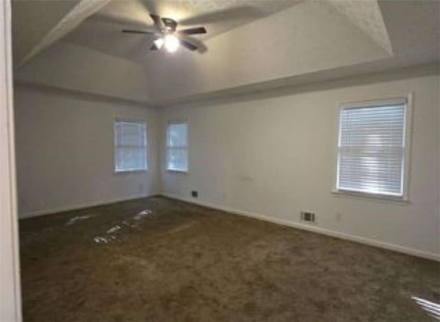 unfurnished bedroom with ceiling fan, carpet floors, visible vents, and baseboards