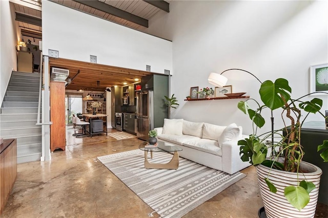 1661 La France St NE Unit 222, Atlanta, GA 30307 - living area featuring stairway, a high ceiling, and finished concrete floors