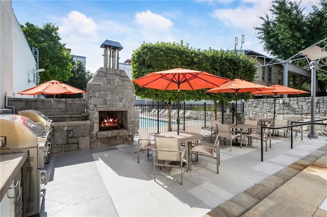 1661 La France St NE Unit 222, Atlanta, GA 30307 - view of patio / terrace with an outdoor stone fireplace
