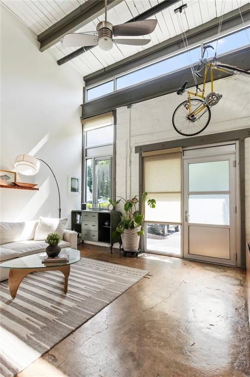 1661 La France St NE Unit 222, Atlanta, GA 30307 - living room with a chandelier, concrete flooring, ceiling fan, and beamed ceiling