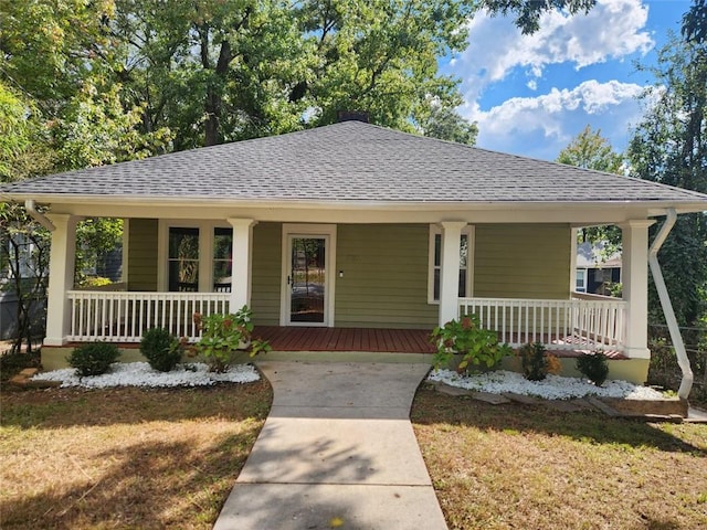 view of front of house featuring covered porch and a front lawn