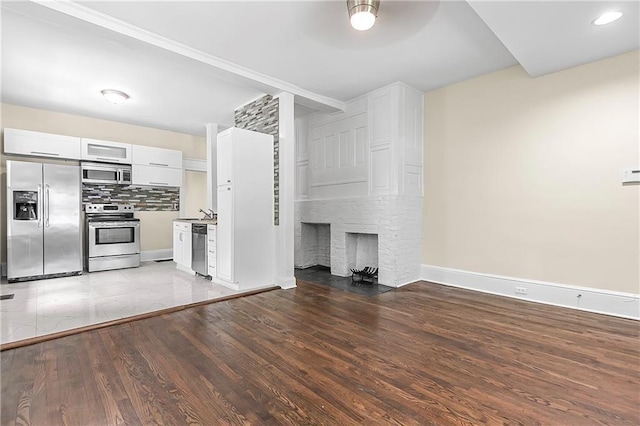 unfurnished living room with a fireplace and light hardwood / wood-style flooring