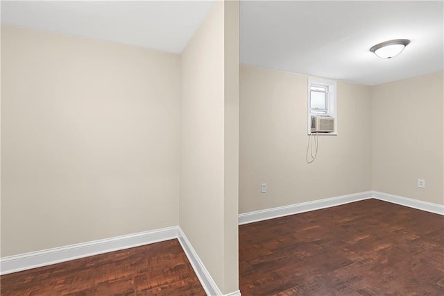 basement with dark hardwood / wood-style floors and cooling unit