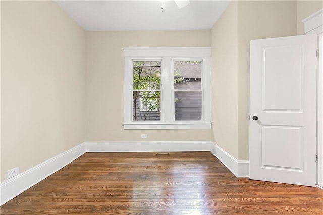 spare room featuring dark hardwood / wood-style floors and ceiling fan