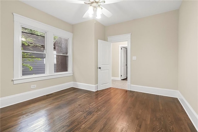 empty room with ceiling fan and dark wood-type flooring