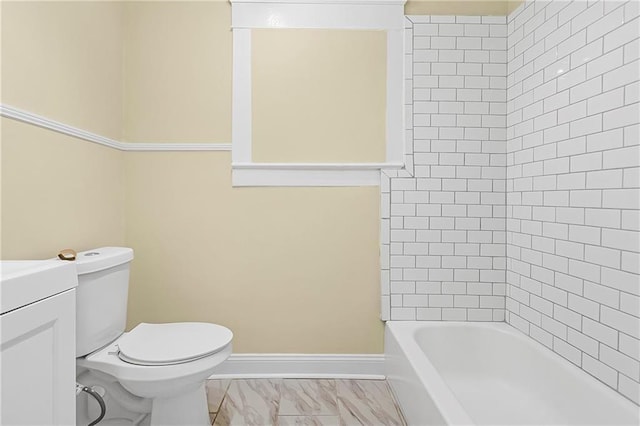 full bathroom with vanity, tiled shower / bath combo, and toilet