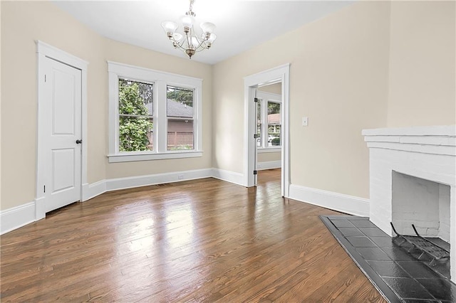 dining room with a fireplace, dark hardwood / wood-style floors, and a notable chandelier