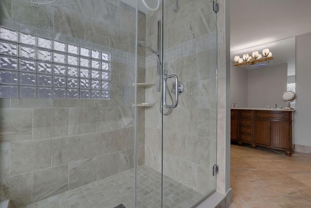 bathroom featuring vanity and a shower with shower door