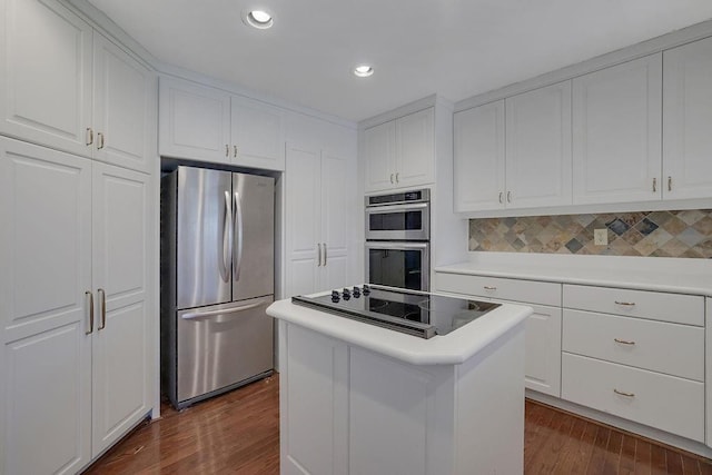 kitchen with dark wood-type flooring, a center island, stainless steel appliances, and white cabinetry