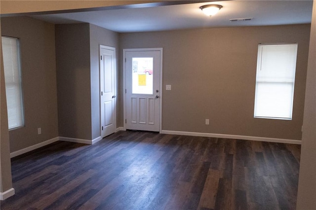 entryway with baseboards, dark wood finished floors, and a healthy amount of sunlight