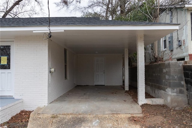 view of parking / parking lot featuring an attached carport and dirt driveway