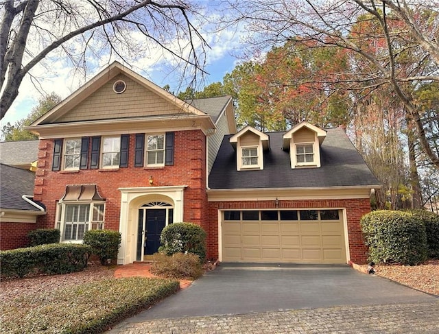 view of front of property featuring brick siding, driveway, and an attached garage