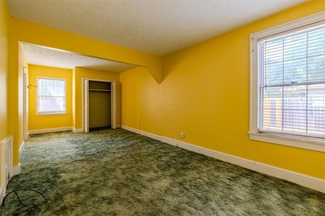 unfurnished bedroom featuring a closet, carpet, and a textured ceiling