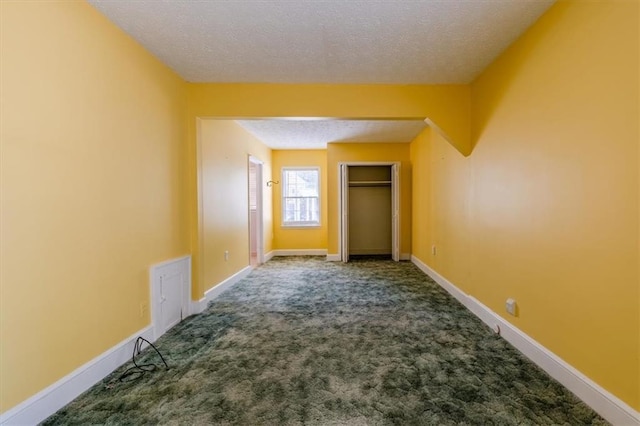 interior space with carpet floors and a textured ceiling