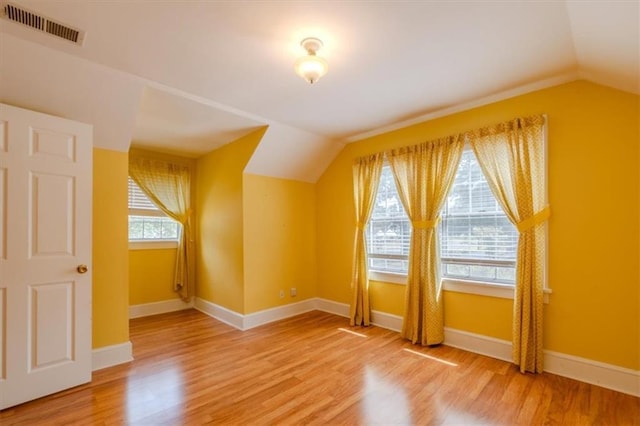 bonus room featuring hardwood / wood-style flooring, lofted ceiling, and a wealth of natural light